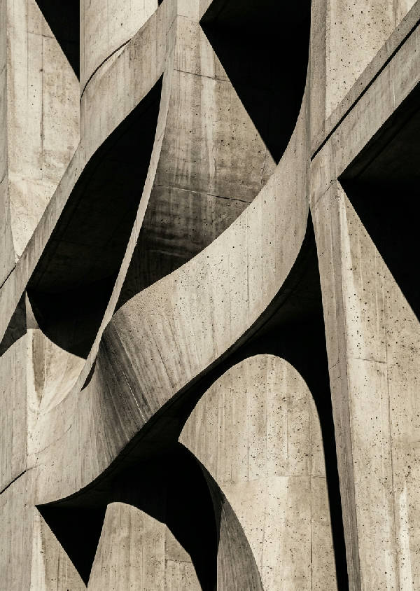 Abstrakt arkitekturfoto i svartvitt med mjuka kurvor, starka skuggor skapar djup och textur.